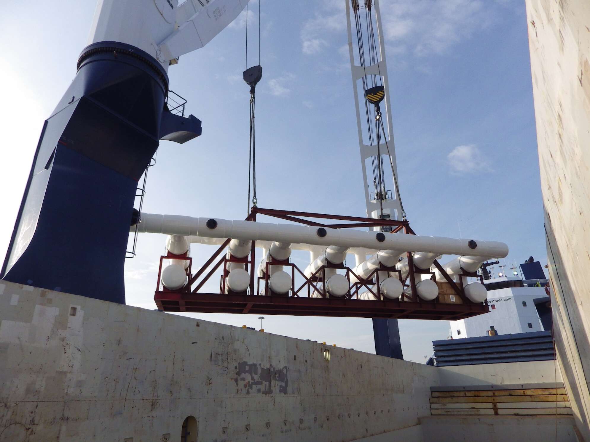 Heavy lifting being done by a crane in the port.