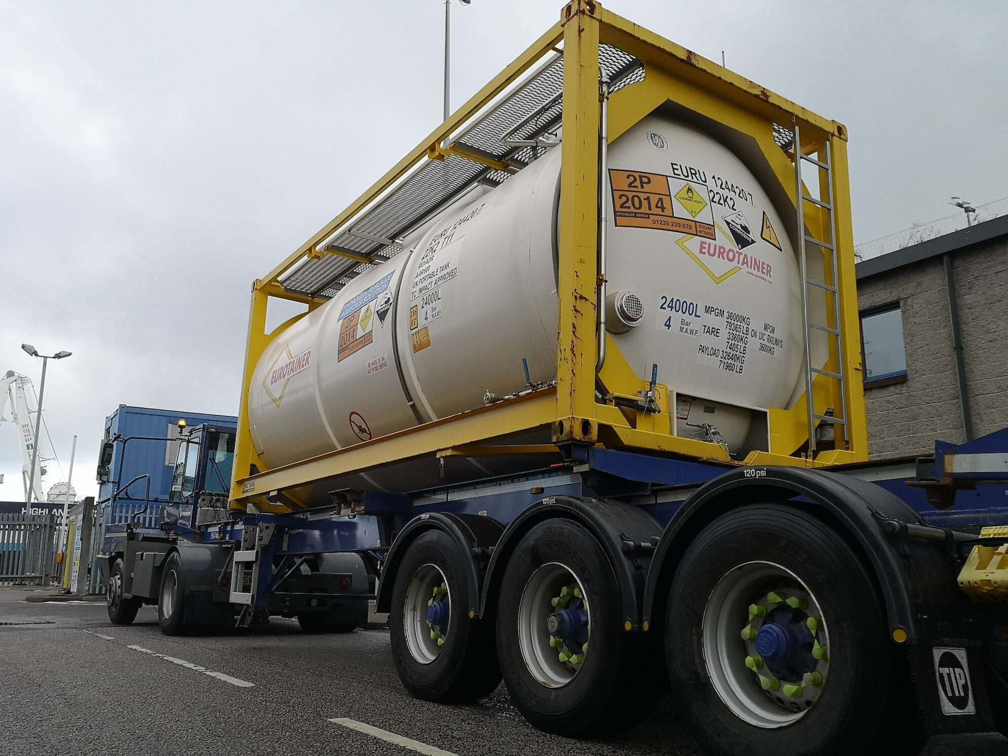 Streamline shipping depot, lorry with hazardous goods trailer getting attached to it.