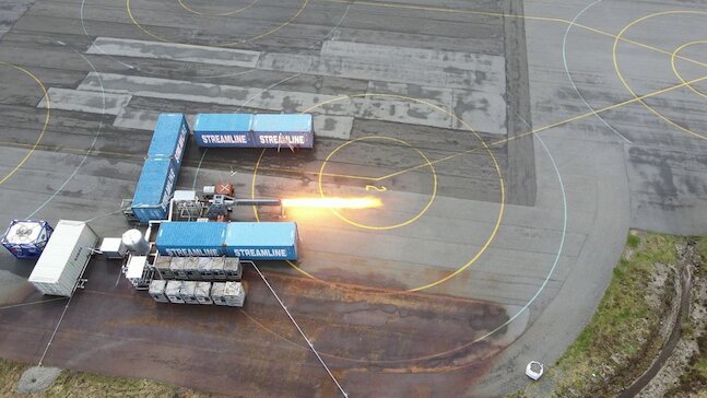 A top-down view of several blue shipping containers outdoors