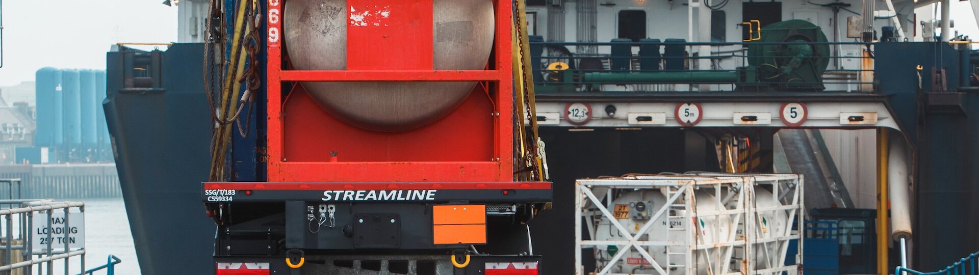 Container ship leaving a UK port representing sea freight services UK and global shipping routes