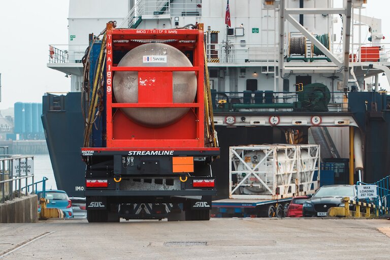 Container ship leaving a UK port representing sea freight services UK and global shipping routes
