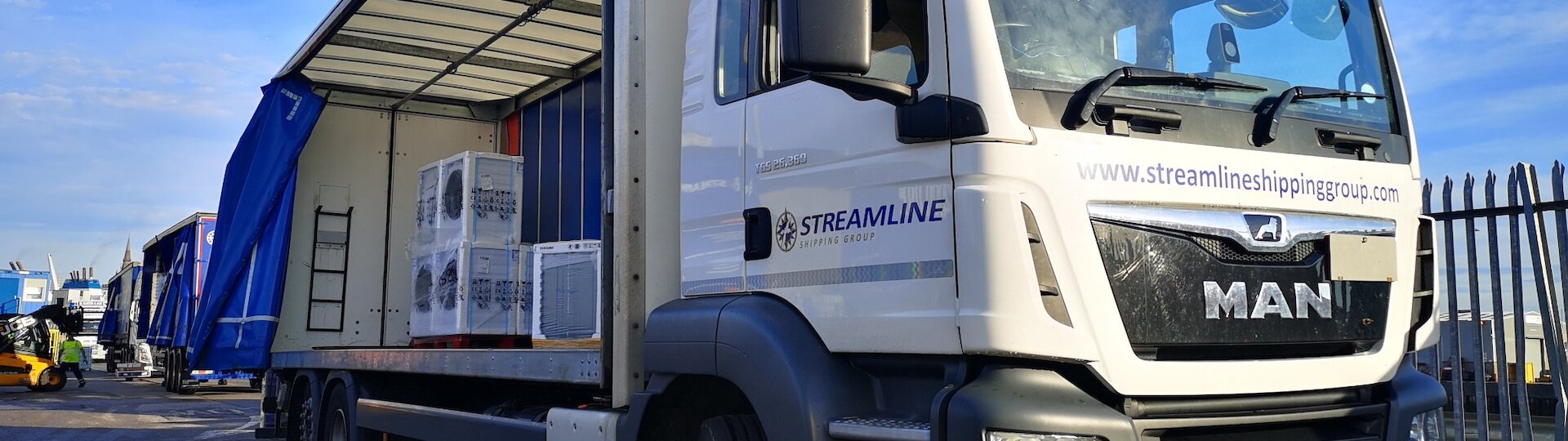 Part load freight truck at depot, showing consolidated shipments from multiple businesses.