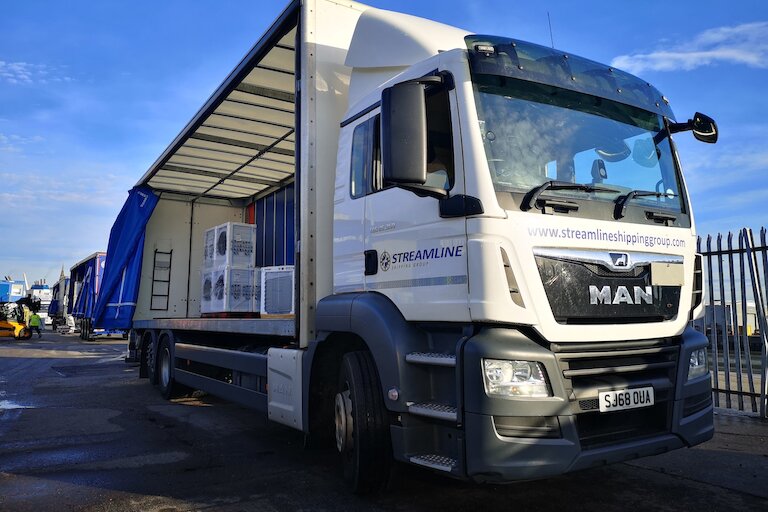 Part load freight truck at depot, showing consolidated shipments from multiple businesses.